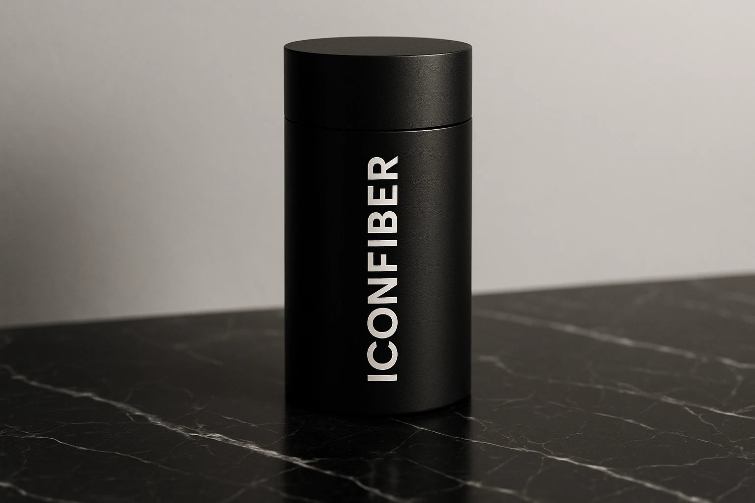 Black cylindrical container with 'ICONFIBER' branding on a marble surface.